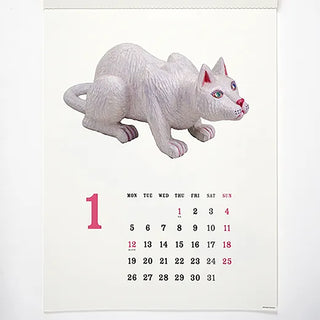 Calendar with a white cat figurine on a white background