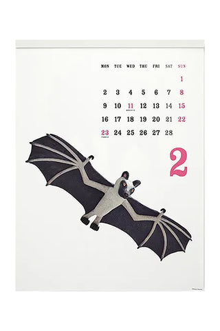 Calendar with a bat figurine on a white background