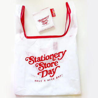 White reusable tote bag with red details that reads "Stationery Store Day. Have a  nice day!"
