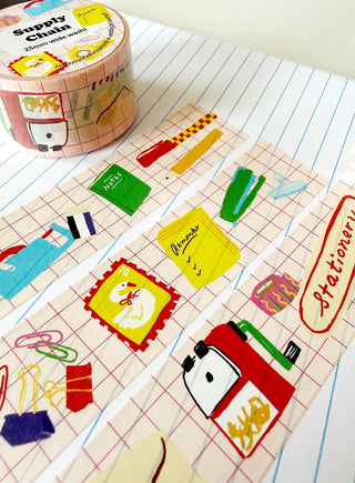 Decorative washi tape with stationery-themed designs on a notebook page.