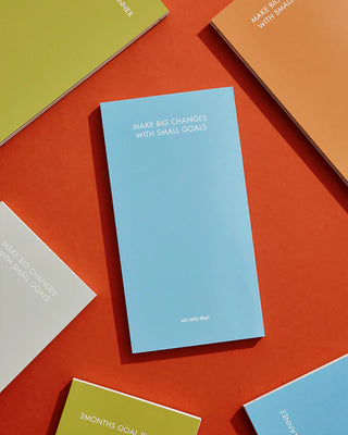 Colorful planner books with text on a red background