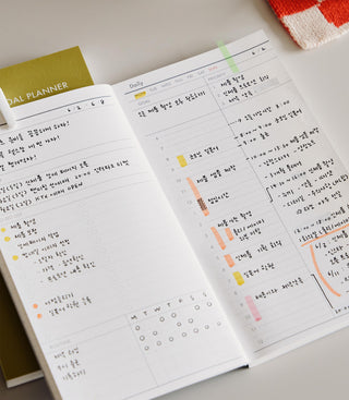 Open daily planner with scheduled tasks and notes on a light surface