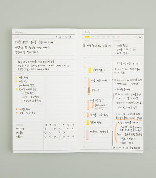 Open planner showing weekly and daily schedules on a gray background