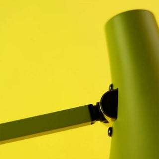 Close up of green lamp on a yellow background