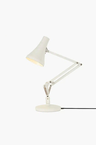 White desk lamp with adjustable arm on a white background