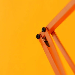 Close-up of the mechanics of the Anglepoise lamp on a yellow background