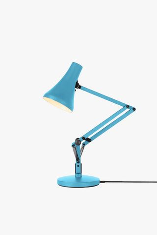 Blue desk lamp with adjustable arm on a white background