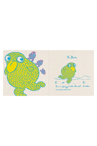 Illustrated book open to a page with a colorful creature and text on a white background