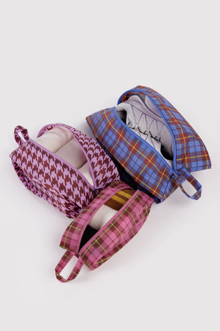 3d zip set of packing pouches in colorful tartan and houndstooth patterns with clothing items inside