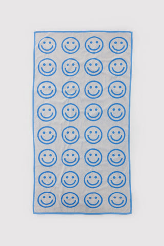 baggu bath towel with white and blue smiley face pattern