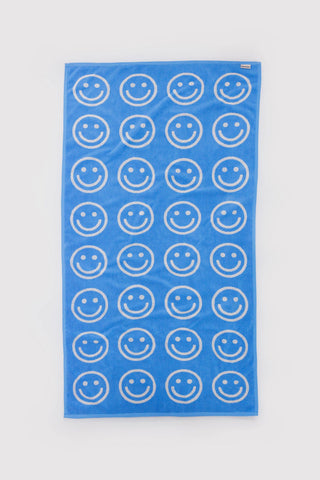 baggu bath towel with blue and white smiley face pattern