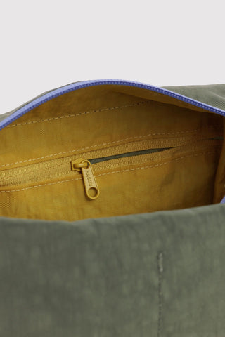 close up of zipper on green baggu dopp kit with colorful accents