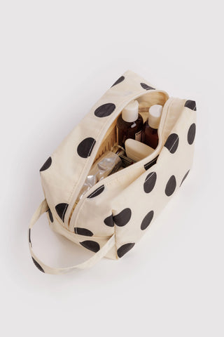 baggu dopp kit with black and white polka dot pattern with toiletry products inside