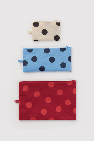 3 set of pouches in polka dot pattern that are white and black, blue, and red