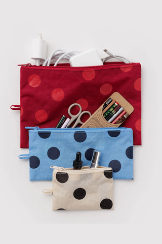 3 set of pouches in polka dot pattern that are white and black, blue, and red with various items inside