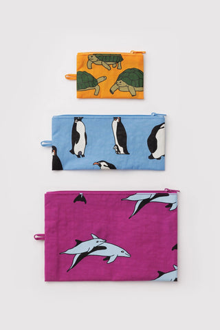 Three pouches with animal prints in size order on a white background