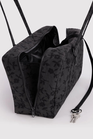 baggu medium bowler bag in black floral pattern opened to show zipper and keychain compartments