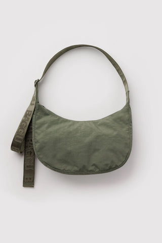 baggu medium crescent bag in caper green on a light background