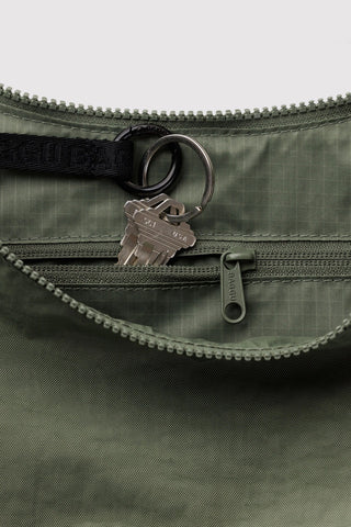 close up of inside zipper compartment on baggu medium crescent bag in caper green