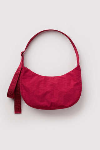 baggu medium crescent bag in cherry red on a light background