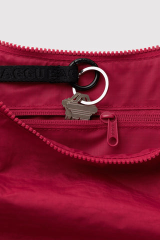 close up of inside zipper compartment with keys on baggu medium crescent bag in cherry red