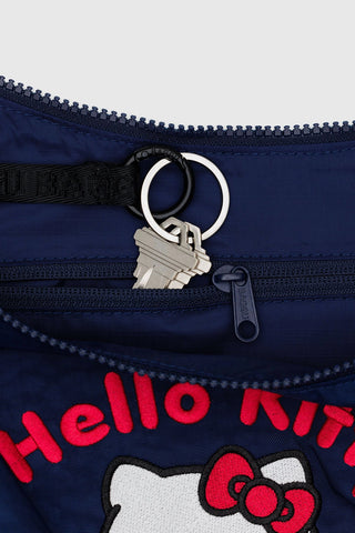 Navy blue bag with Hello Kitty design and keychain on a white background