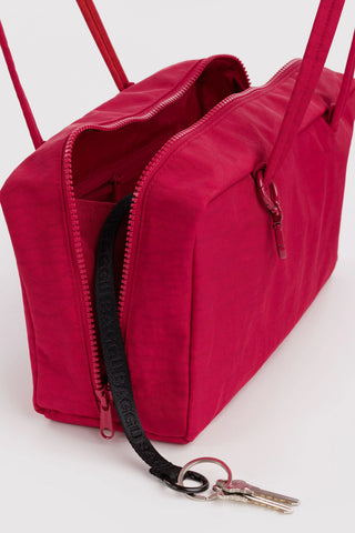 nylon bowler bag in cherry red colorway opened showing zipper and keychain compartments 