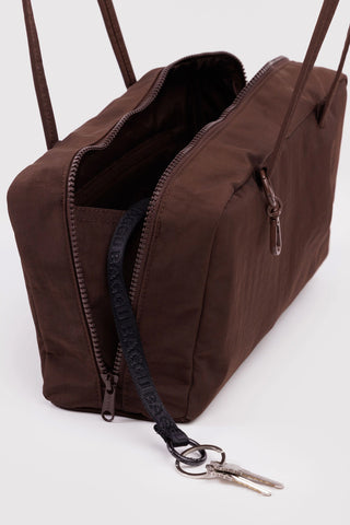 nylon bowler bag in coffee brown colorway opened showing zipper and keychain compartment