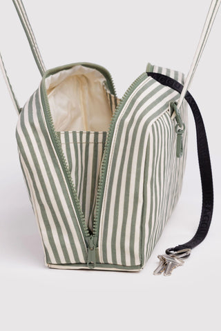 Green and white striped bag with a black strap on a white background