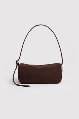 Brown handbag with a strap on a light gray background