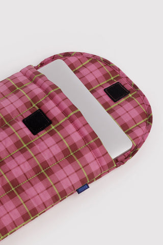 laptop sleeve with pink and green tartan pattern opened with device inside on a light background