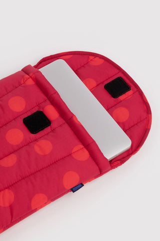 baggu laptop sleeve with red polka dots opened with device inside on a light background