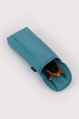puffy glasses sleeve in teal peacock color opened with sunglasses inside on a light background