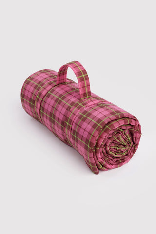  baggu puffy picnic blanket rolled up in a pink tartan pattern with handle