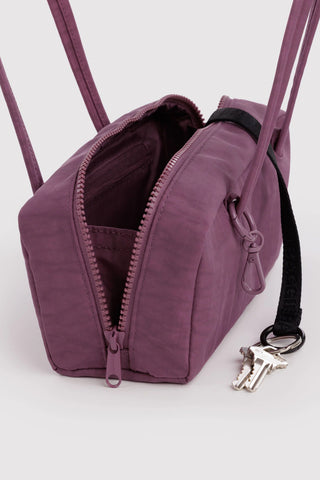 small bowler bag opened showing zippers and keychain compartments