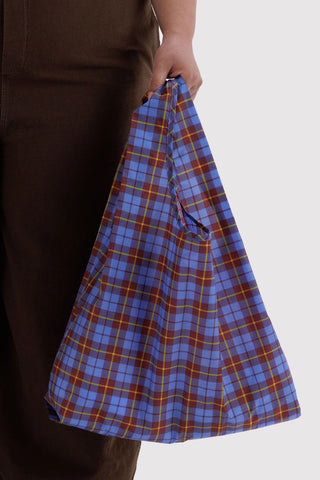 person holding blue and yellow tartan patterned baggu tote