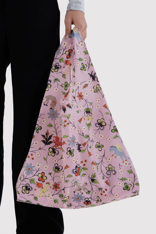 hand holding pink baggu tote bag with flowers and animals print