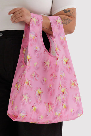 Person holding pink reusable tote with star pattern