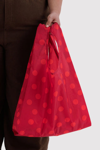 hand holding red polka dot baggu tote 