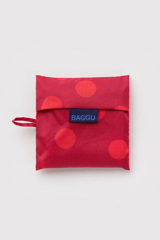 folded red polka dot baggu tote on a light background