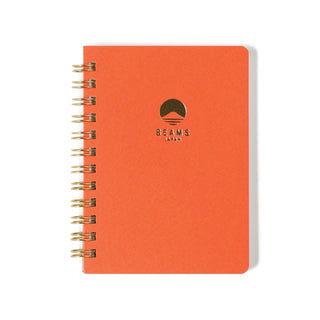 Orange notebook with beams japan logo on the cover against a white background