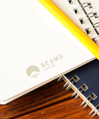 Notebook with spiral binding and 'Beams Japan' branding on a white background