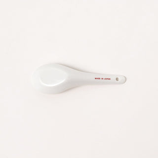 Back of white ceramic spoon with 'Made in Japan' text on a white background