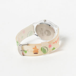 Wristwatch with a colorful dessert patterned band on a white background