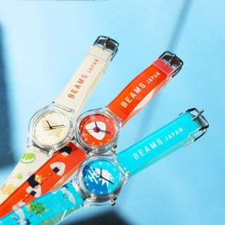 Three colorful watches with 'BEAMS JAPAN' branding on a blue background