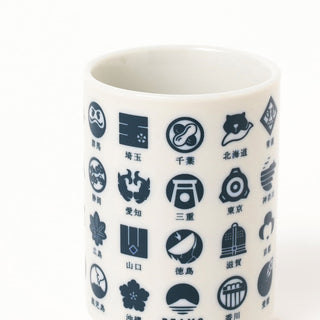 White mug with navy symbols and text on a white background