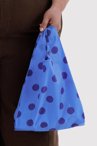 hand holding tote bag with blue polka dot print