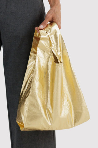 Gold metallic baby BAGGU tote bag, hand-held with short handles