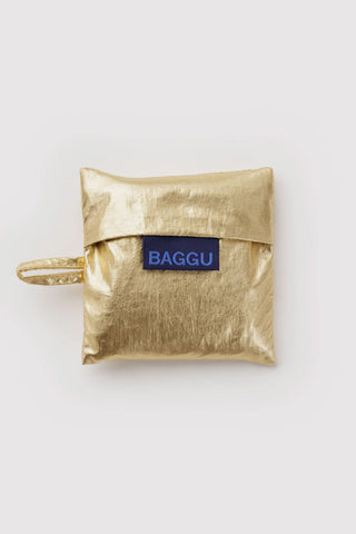 Gold metallic baby BAGGU pouch with wrist strap and blue logo patch