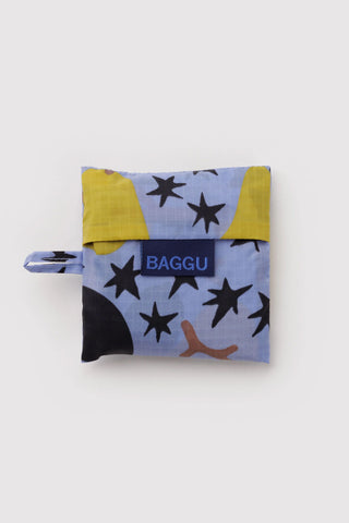 Baby BAGGU tote bag folded with BAGGU logo, navy and yellow stars pattern